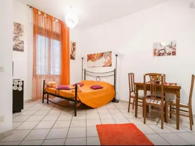 a bedroom with a bed and a table and chairs at San Giovanni In Laterano Daniela Apartment in Rome