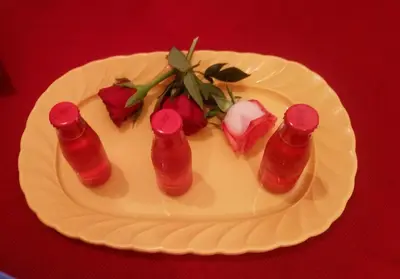 a white plate with red sauce and roses on it at San Giovanni In Laterano Daniela Apartment in Rome