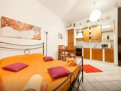 a bedroom with a wooden bed in a kitchen at San Giovanni In Laterano Daniela Apartment in Rome
