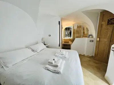 a bedroom with a white bed with towels on it at Casa Cavour in Rome