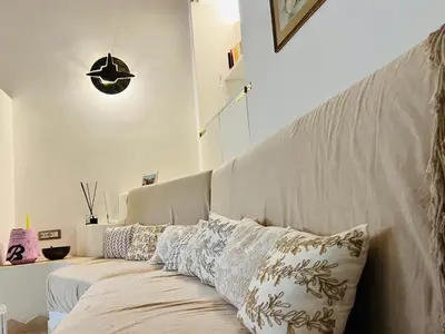a couch with pillows on it in a room at Casa Cavour in Rome