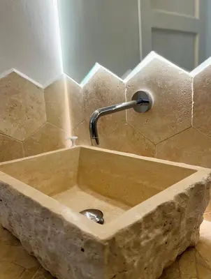 a stone sink with a faucet in a bathroom at Casa Cavour in Rome