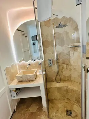 a bathroom with a sink and a shower at Casa Cavour in Rome