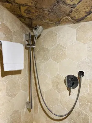 a shower with a shower head in a bathroom at Casa Cavour in Rome
