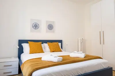 a bedroom with a large bed with towels on it at Pandolfo Apartment in Rome