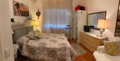 a bedroom with a bed and a dresser with a mirror at A Casa di Silvana in Rome