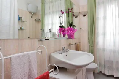a bathroom with a sink and a toilet and a mirror at A Casa di Silvana in Rome