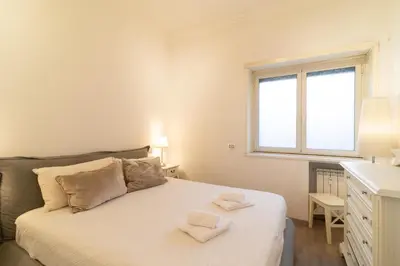 a bedroom with a bed with two towels on it at Ponte Milvio Holiday Home in Rome
