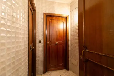 a hallway with a wooden door in a room at Ponte Milvio Holiday Home in Rome