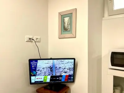 a computer monitor sitting on a wooden stand in a room at The Stylish at Ponte Milvio in Rome