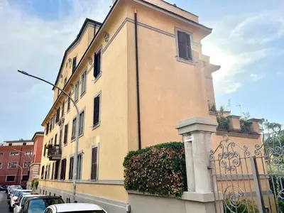 a large building with cars parked in front of it at The Stylish at Ponte Milvio in Rome