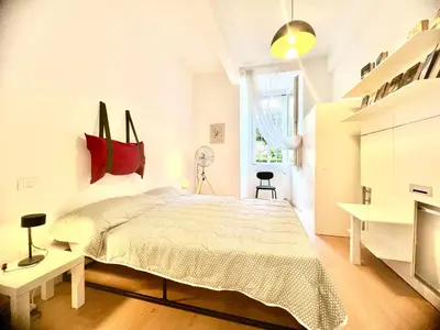a white bedroom with a bed and a fireplace at The Stylish at Ponte Milvio in Rome