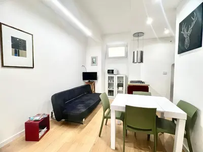a living room with a table and a couch at The Stylish at Ponte Milvio in Rome