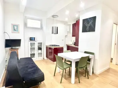 a kitchen and dining room with a table and chairs at The Stylish at Ponte Milvio in Rome