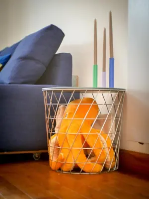 a basket of oranges on the floor next to a couch at Stunning 3-Bedroom Penthouse in Rome