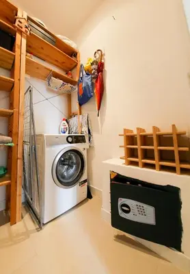 a laundry room with a washer and a washing machine at Stunning 3-Bedroom Penthouse in Rome