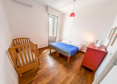a small room with a bed and a chair at Stunning 3-Bedroom Penthouse in Rome