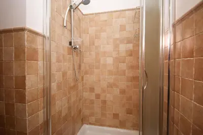 a shower with a glass door in a bathroom at Yellowmat by Ghor in Rome