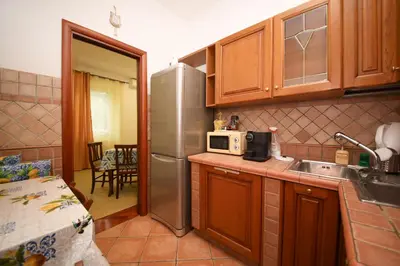 a kitchen with a stainless steel refrigerator and a microwave at Yellowmat by Ghor in Rome