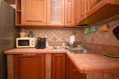 a kitchen with a sink and a microwave at Yellowmat by Ghor in Rome