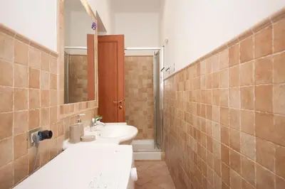 a bathroom with a sink and a tub and a mirror at Yellowmat by Ghor in Rome