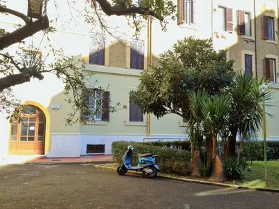 a blue scooter parked in front of a building at Domò Vaticano Guest House in Rome