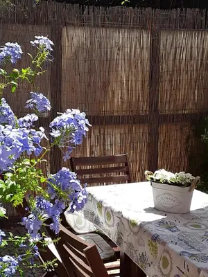 a table and chairs with purple flowers on it at L'Incantevole Aventino in Rome