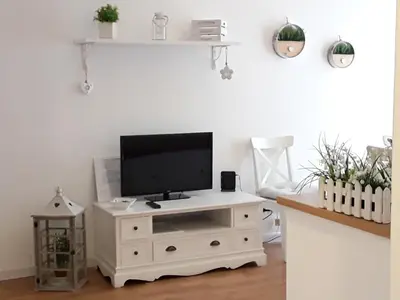 a white entertainment center with a flat screen tv on it at L'Incantevole Aventino in Rome