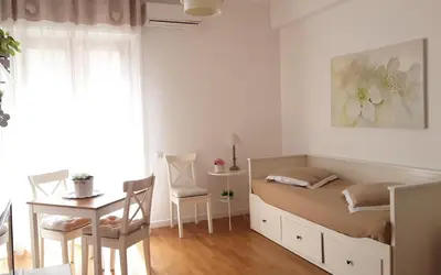 a bedroom with a bed and a table and a desk at L'Incantevole Aventino in Rome