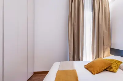 a bed with two pillows and a window in a room at JOIVY Cavour 238 in Rome