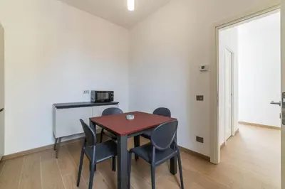 a dining room with a table and four chairs at JOIVY Cavour 238 in Rome