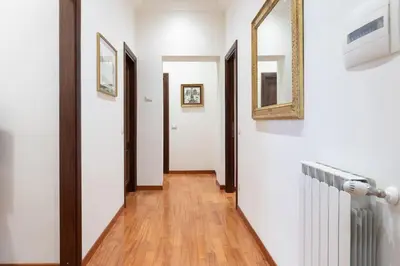 a bathroom with a toilet and a sink and a mirror at Elegant Salandra Suite in Rome