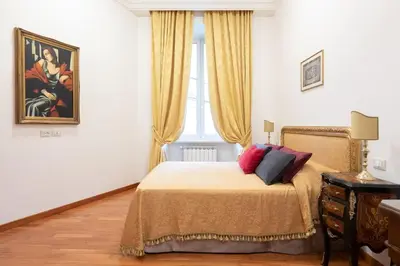 a bedroom with a bed and a wooden door at Elegant Salandra Suite in Rome