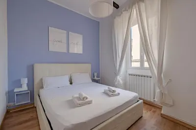 a bedroom with a white bed with towels on it at Apartment B5 in the center of Rome WiFi and AC in Rome
