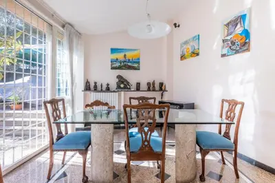 a dining room with a glass table and chairs at Residenza Latina -Charme & Relax in Rome