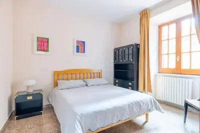 a bedroom with a large white bed and a window at Residenza Latina -Charme & Relax in Rome
