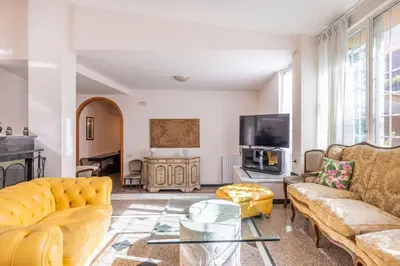 a living room with yellow furniture and a tv at Residenza Latina -Charme & Relax in Rome