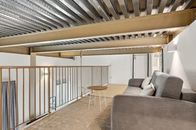 a living room with a couch and a table at Limehome Rome Via Fortebraccio in Rome
