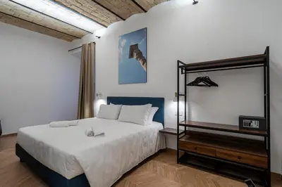 a blue couch in a living room with a lamp at Urban Vatican Rooms in Rome