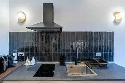 a kitchen with a sink and a stove at Urban Vatican Rooms in Rome