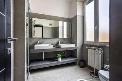a bathroom with two sinks and a mirror at Charme & Luxe 2 bedroom apartment City Center in Rome