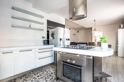 a kitchen with white cabinets and a stove top oven at Charme & Luxe 2 bedroom apartment City Center in Rome