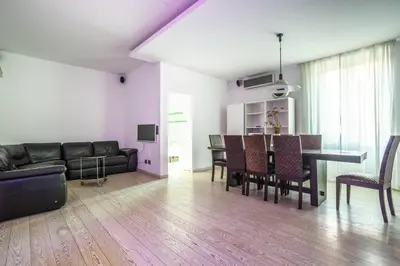 a living room with a couch and a table and chairs at Charme & Luxe 2 bedroom apartment City Center in Rome