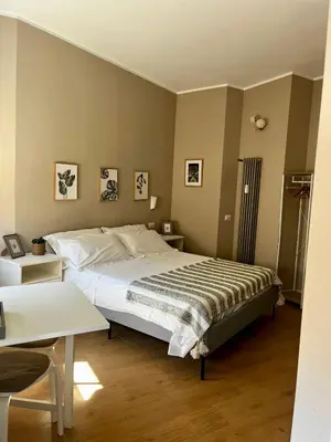 a bedroom with a large bed in a room at Romanamente Suite in Rome