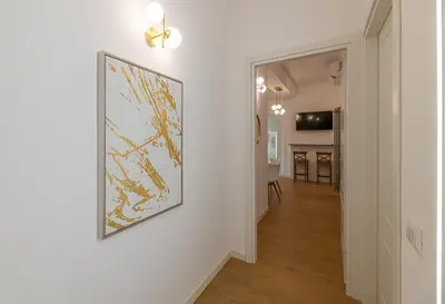 a hallway with a framed map on a wall at Romanamente Suite in Rome