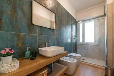 a bathroom with a sink and a toilet and a mirror at Romanamente Suite in Rome