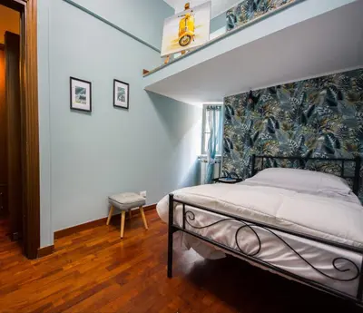 a bedroom with a bed and a wall at Vicolo 35 in Rome