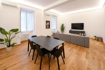 a living room with a black table and chairs at Ferrari 12 Apartment - Vaticano in Rome