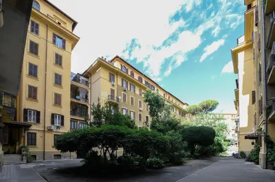 a row of buildings in a street with trees at Ferrari 12 Apartment - Vaticano in Rome