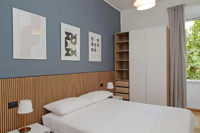 a bedroom with a white bed and a blue wall at Doria in Rome